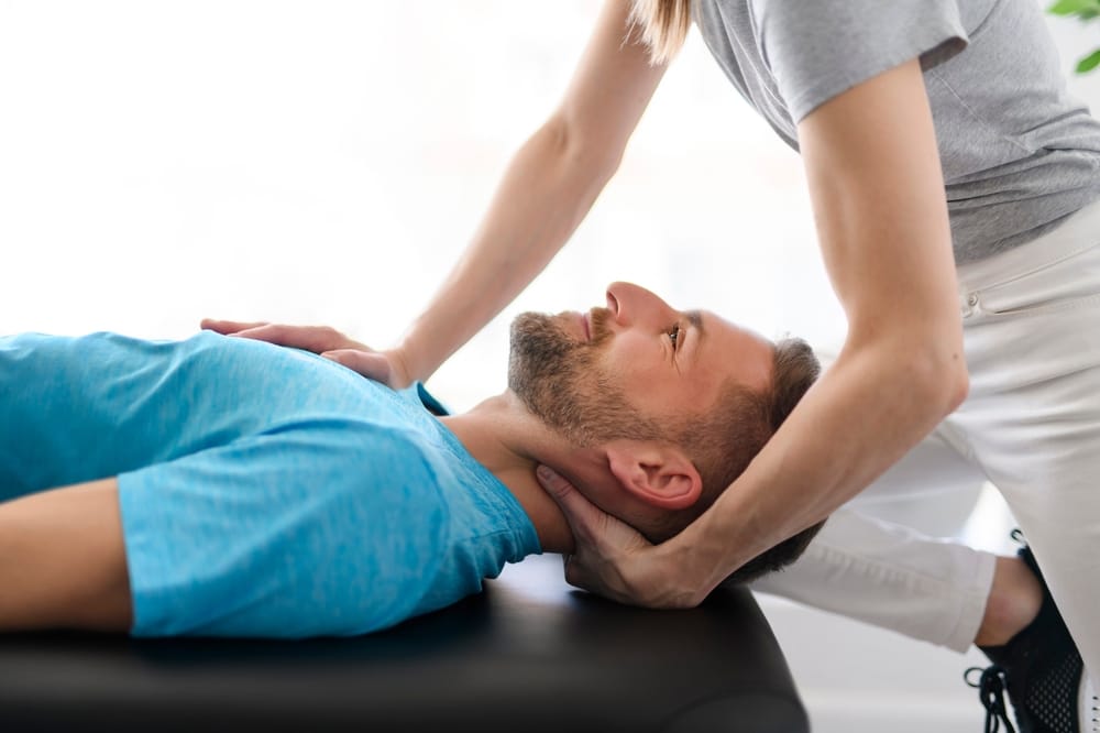 Hands-On Neck Therapy - Corrective Exercises A patient receives professional neck therapy to enhance alignment, relieve tension, and support recovery through Corrective Exercises.