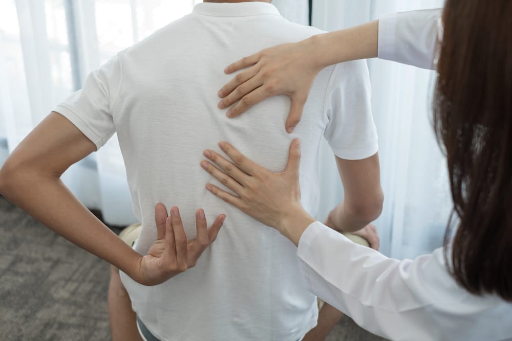 Back Posture Assessment - Manual Adjustment A therapist evaluates and supports spinal posture to improve alignment, reduce pain, and restore function during care - Manual Adjustment.