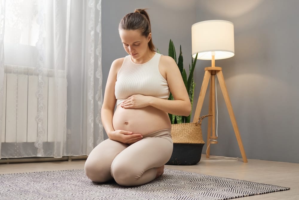 Prenatal Wellness and Support - Pregnancy & Pediatric Care A pregnant woman practices gentle self-care, focusing on comfort and wellness for a healthy pregnancy journey - Pregnancy & Pediatric Care.
