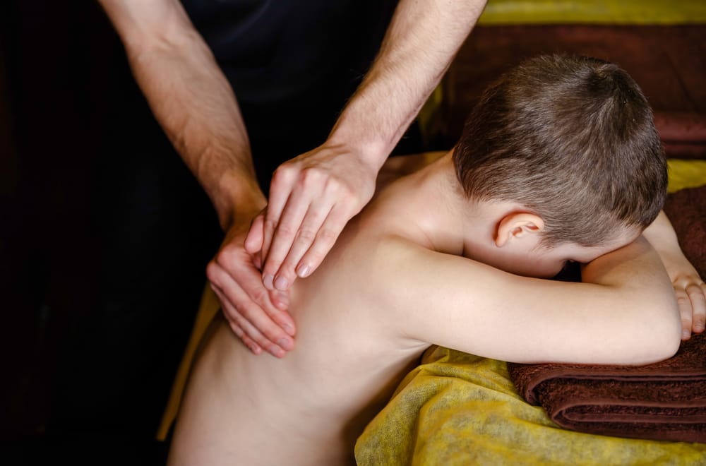Child Back Therapy Session - Pregnancy & Pediatric Care A child receives gentle back therapy to support posture, growth, and overall well-being - Pregnancy & Pediatric Care.