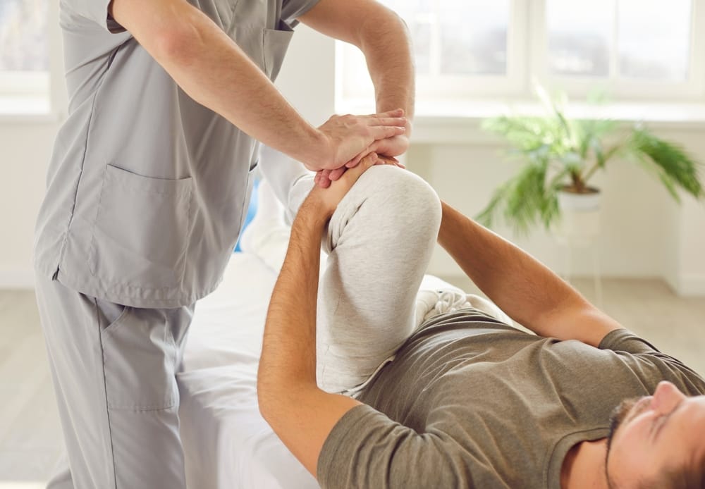 Knee Therapy and Joint Care - Rehabilitation A therapist helps improve knee flexibility and joint strength through targeted therapy for recovery and mobility enhancement - Rehabilitation.