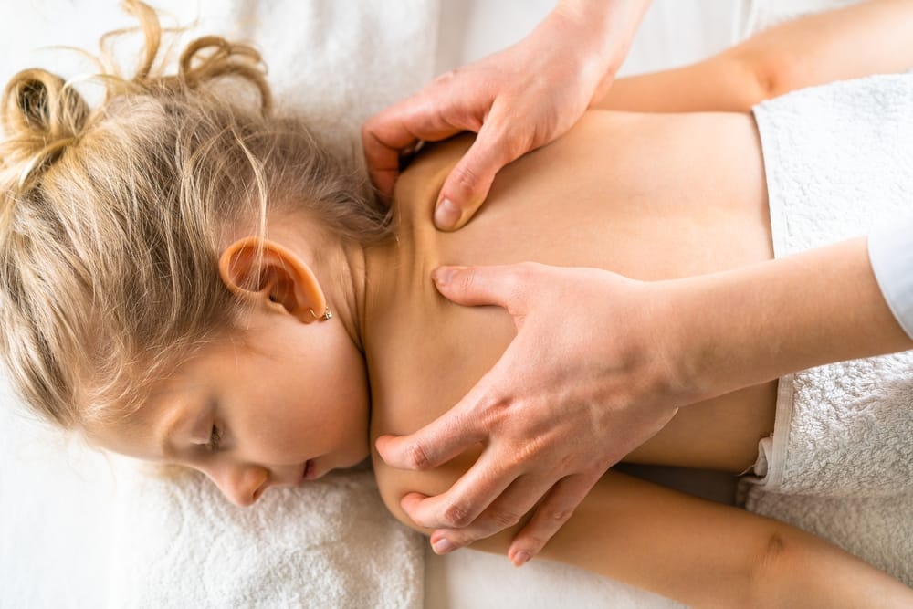 Pediatric Back Care Therapy - Pregnancy & Pediatric Care A young girl receives supportive back therapy designed to improve comfort, alignment, and healthy development - Pregnancy & Pediatric Care.
